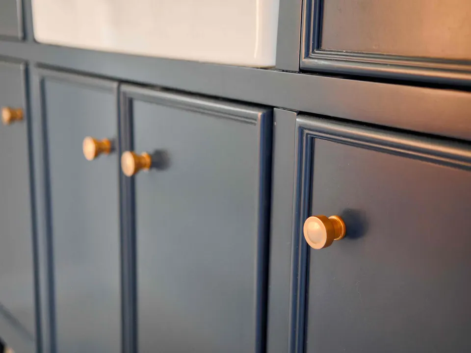 Navy shaker cabinet doors with brass knobs