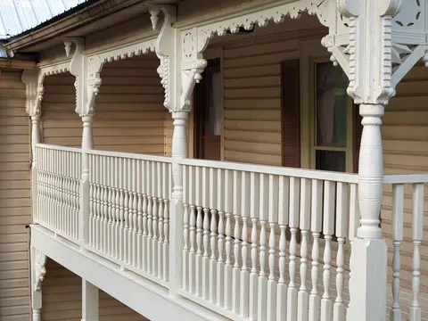 Porch with turned spindle railings, carved brackets and gingerbread trim