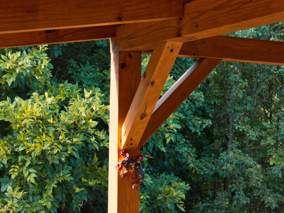 Timber post and knee braces on an open-air covered deck