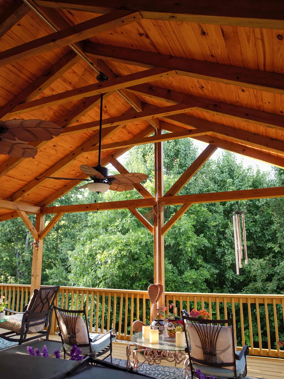Vaulted timber-frame roof with exposed trusses over a covered deck