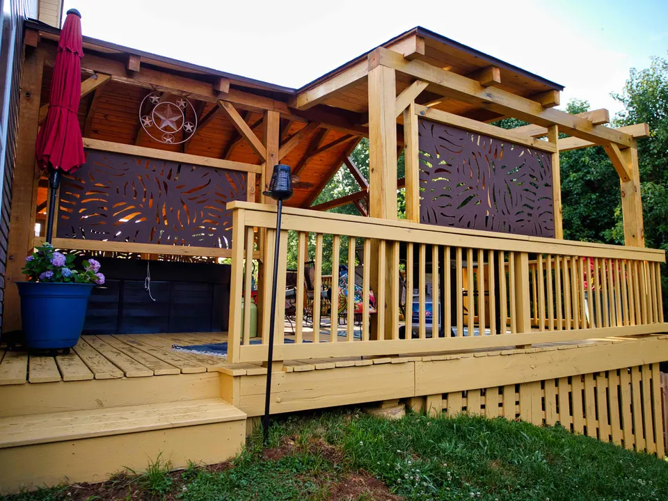 Wood deck with a timber pavilion roof, pergola extension and decorative privacy screens