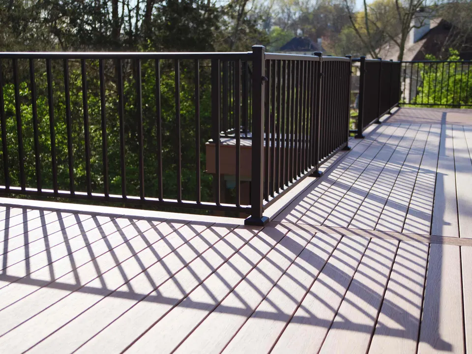 Composite deck boards and black aluminum railing on an elevated deck